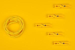 Yellow clothespins and rope. photo