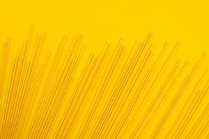 Italian pasta, copy space, yellow background photo