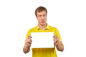 Suspicious guy holding blank paper sheet, paper mockup isolated on white background photo