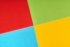 Red, green, blue, yellow paper colours. Corporation logo concept. photo