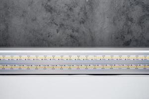 Strip LED light with aluminum profile on stretch ceiling, close up. Home renovation concept photo