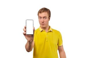 Young man with smartphone mockup in hand, white isolated background, mobile app advertise photo