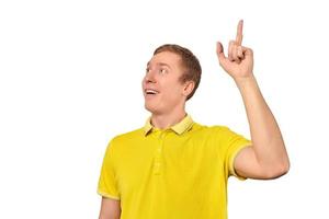 Smiling young man in yellow T-shirt with eureka gesture, man got idea isolated on white background photo