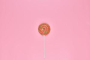 Sweet lollipop on pink background photo