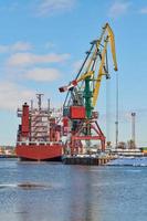 Moored ships and harbor cranes in port photo