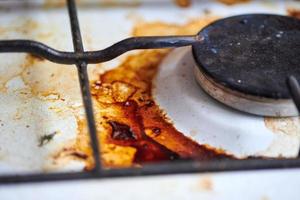 Dirty stove with food leftovers photo