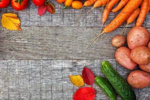 Assortment different fresh organic vegetables on country style wooden background. Healthy food vegan vegetarian dieting concept. Local garden produce clean food. Frame top view flat lay copy space. photo