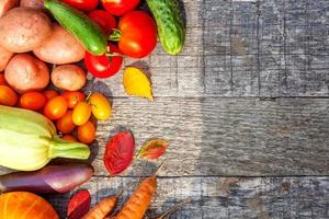 Assortment different fresh organic vegetables on country style wooden background. Healthy food vegan vegetarian dieting concept. Local garden produce clean food. Frame top view flat lay copy space. photo