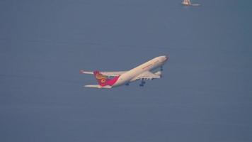 HONG KONG NOVEMBER 10, 2019 - Hong Kong Airlines Airbus A330 airliner climbing up in the air right after take off from Chek Lap Kok international airport, Hong Kong. video