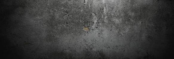 paredes oscuras y aterradoras, textura de cemento de hormigón negro ligeramente claro para el fondo. cepillo de arañazos en la pared foto
