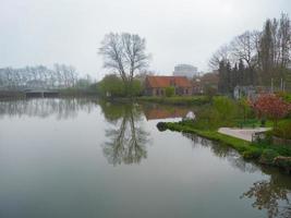 Beautiful scene Water reflect Lakeside in the green park of Brugge Belgium photo