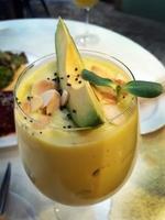 Selective focus close up freshness of avocado almond smoothie drink in the glass with decoration photo