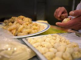 Close up local chef hand making raw shrimp wontons, dumpling, traditional style, famous local hong kong chinese cantonese food, selective focus photo