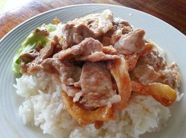 close-up stir fried garlic with slice pork top over rice with cucumber and soup Thai local food photo