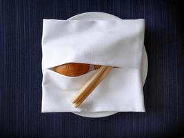 cclose-up warmed various kind of bread and bread sticks serving in the white napkin covered creative design with blue background photo