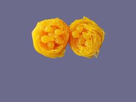 Top view Close up of Thai style Fios de ovos, rolled golden egg yolk thread, traditional sweet food dessert, cut out isolated with copy space photo