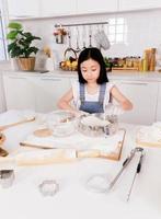 Little single child make a bake in the kitchen photo