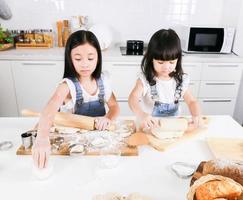 Cute happy little two child have fun baking in the kitchen photo