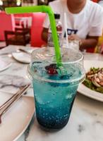 Close up Cup with blue hawaii soda cocktail on the table photo