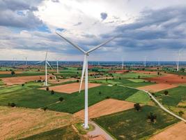 Panoramic view of wind farm or wind park, in the meadow field  are one of the cleanest, renewable electric energy source. with high wind turbines for generation electricity. Green energy concept. photo