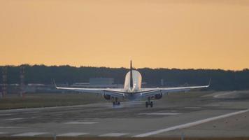 FRANKFURT AM MAIN, GERMANY JULY 19, 2017 - Lufthansa Cityline Embraer 190 D AECE lands on the illuminated runway in the early morning video