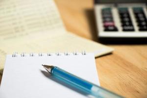 Background of passbook, note book with pen, calculator photo