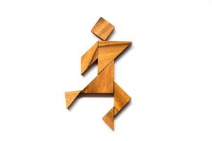 Wooden tangram as happy man shape on white background photo