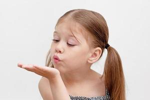 Child blowing on palm photo