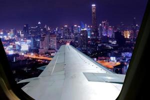 Evening flight on twilight sky, amazing view from the window plane. Window seat on airplane overlooking  city at night view . photo