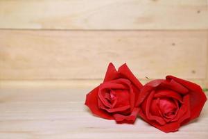 Design Beautiful red roses on old aged wood background. valentine concept. Space for text. photo