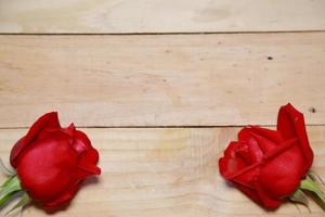 Design Beautiful red roses on old aged wood background. valentine concept. Space for text. photo