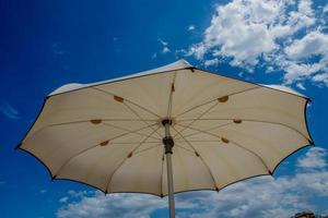 White umbrellas open on the beach photo