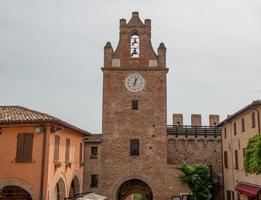 Ancient brick tower with clock photo