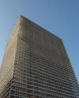 Building with scaffolding and protective sheets photo