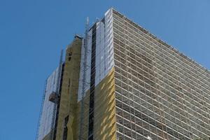 Building with scaffolding and protective sheets photo