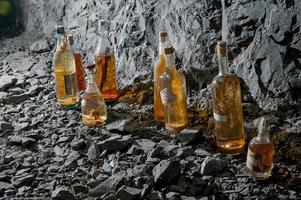 Liquor bottles aged in the mine photo