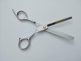 Stainless steel scissors on a white background give the hairdresser hair clipper concept. photo