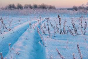 winter landscape, tire tracks on the snow, snow road photo