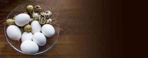 Different eggs background. Quail eggs on white dish, There are many sizes and patterns are different. photo