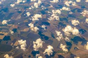 Aerial photo of Farmland. view from the plane to the ground. squares of fields under the clouds