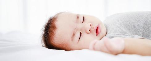 Close-up portrait of a sleeping newborn baby, banner size photo