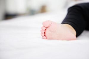 retrato de primer plano de pies de bebé y un bebé recién nacido dormido