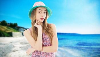 Young happy woman on the beach in summer vacation photo
