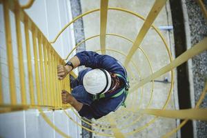 Male climb the stairway storage visual inspection tank photo