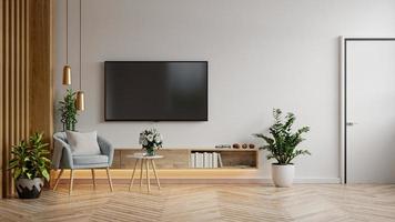 Mockup TV cabinet in modern living room with blue armchair and plant on white wall background.