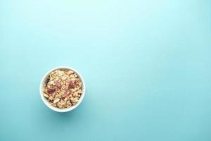 Home Made Musli in a bowl on light green background photo