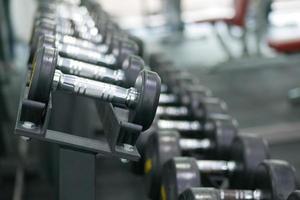 Dumbbell, barbell in the gym with copy space . photo