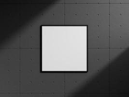 Clean and minimalist front view square black photo or poster frame mockup hanging on the industrial brick wall with shadow. 3d rendering.