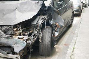 black car damaged by a road accident photo