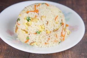 cooked fried rice in a bowl on table, close up, photo